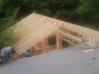 Framing a new roof addition that ties into an existing shingle roof in Wixom